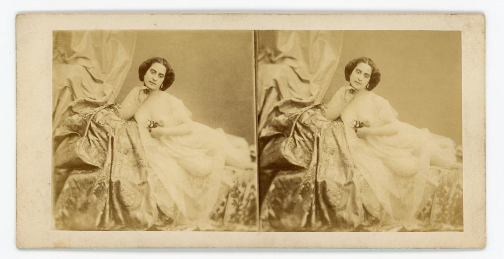 Vintage stereo card portrait of a woman reclining