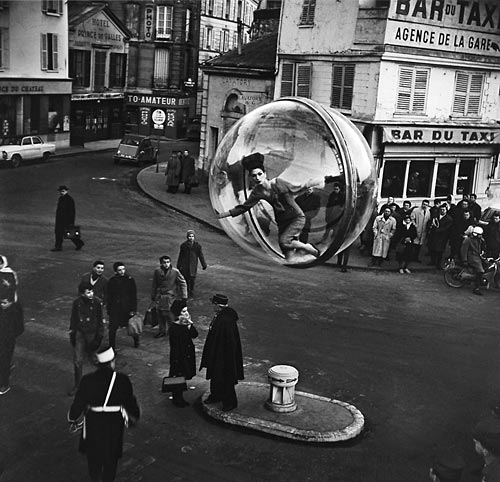 Fashion model floating in a bubble over Paris street